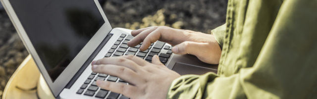 Cropped close up of female organic farmer typing on laptop Cropped close up of female organic farmer typing on laptop 