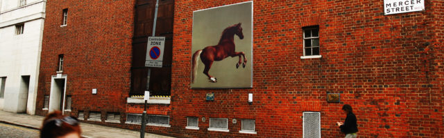 National Gallery Presents Art On London's Streets LONDON - JUNE 12: Passers by walk past a reproduction of George Stubbs painting, Whistlejacket on June 12, 2007 in London, England. The Grand Tour, is an exhibition on the streets of London's SOHO area, consisting of 30 full sized re-creations of National Gallery Paintings. (Photo by Daniel Berehulak/Getty Images) 