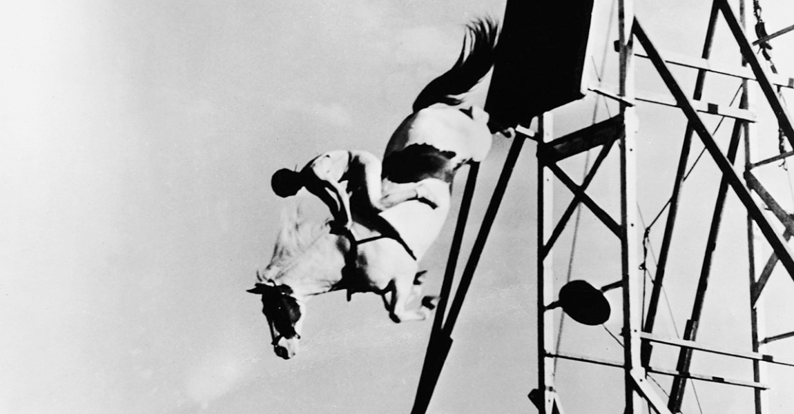 Sonora Carver High-Dives On Horseback Circus performer Sonora Carver attempts a stunt high-dive on horseback, jumping toward a swimming pool below, 1961. (Photo by Hulton Archive/Getty Images) 